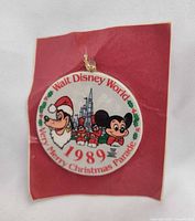 Front of round porcelain ornament showing graphics and text