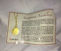 Necklace on informational card showing full text and pendant