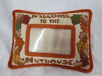 Front view of vintage decorative pillow showing photo pocket, text and leaf/acorn motif