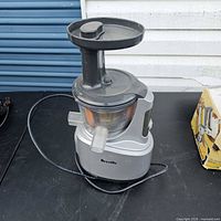 Full view of Breville vertical masticating juicer on countertop