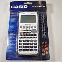 Front view of calculator sealed in original clamshell packaging