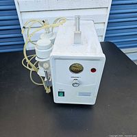 Front view showing gauge, controls, canister and tubing