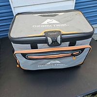 Front view of Ozark Trail grey soft-sided cooler with zippered front pocket