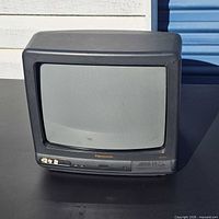 Front view of Panasonic 13-inch CRT showing screen, control panel, speaker grille