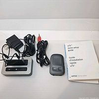 Full lot showing transmitter, dock, power adapter, RCA cable, manual