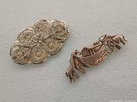 Both brooches front view