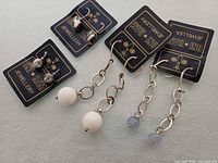 Four pairs of sterling silver earrings on Oni Ram cards