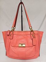 Front view showing overall design, front pocket, hardware and straps