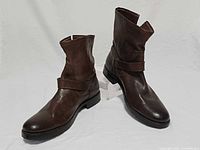Pair of brown leather Frye Natalie short boots angled side view