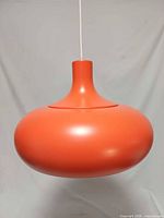 Front view of orange pendant lamp showing overall form
