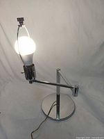 Full view of chrome table lamp illuminated