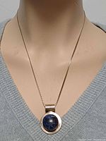 Necklace on bust showing pendant scale and chain style