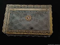 Top view showing etched lid design and rhinestone accent