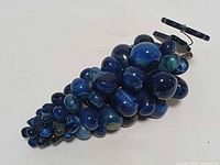 Full view of cobalt blue glass grape cluster showing overall form