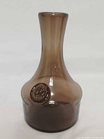 Front view of brown glass vase/carafe with applied seal