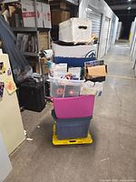 Stacked plastic totes and cardboard boxes containing the vinyl singles lot