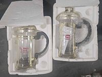 Two French presses in styrofoam packaging