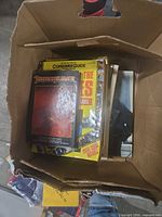 Box containing stack of paperback books