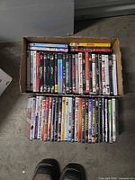 Entire open box showing two rows of roughly fifty DVD cases