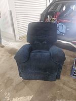 Front view of navy fabric recliner showing tufted back, pillow arms and overall wear