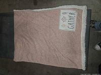 Dusty pink sherpa-backed blanket with Gather patch