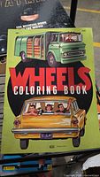 Front cover of Wheels Coloring Book showing full artwork and title