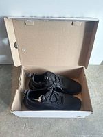 Shoes inside open Adidas box