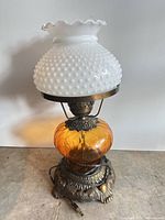 Full lamp showing shade, amber globe, metal base and cord