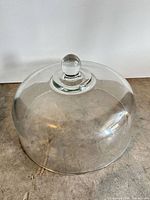 Front angled view of clear glass cake dome lid