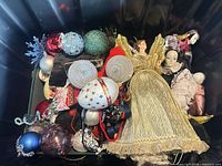 Overview of tote showing angel, dolls and various ornaments