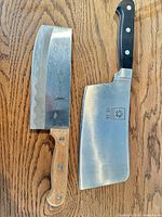 Two cleavers side by side showing full blades and handles