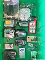 Entire lot in green tote showing all electronics and media
