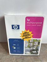 Front view of sealed HP multipurpose paper ream showing specifications: 8.5"x11", 500 sheets, 20 lb, 92 brightness