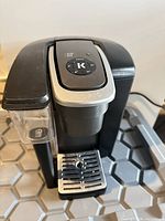 Front view showing Keurig branding, removable reservoir and drip tray