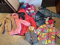 Group shot of all seven outerwear items laid out