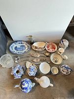 All items in lot laid out on floor including porcelain, glass and utensils