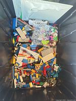 Overview of bin with mixed LEGO pieces and baseplates visible