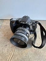 Front angled view showing camera body, lens, strap