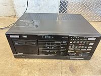 Front view showing full unit, cassette door, tuner display