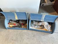 two open blue storage bins with tools and hardware