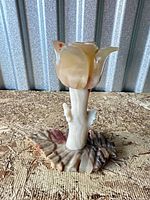 Front view of carved onyx tulip flower sculpture showing blossom, stem and base