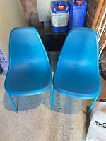 Front view of both blue plastic chairs