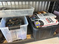 Two plastic bins containing numerous CD jewel cases and box sets