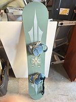 Full view of snowboard with bindings