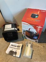 Heater, manual, water bottle, accessory pack, and box displayed together