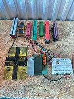 All items laid out: locomotive, six freight cars, power pack, track crossings, base section