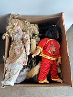Box with six vintage dolls visible