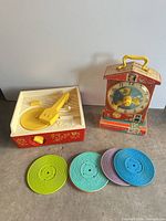 Record player, teaching clock and four discs grouped