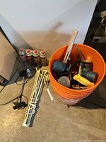 overall lot showing butane cartridge pack, swing-arm lamp, orange bucket with tools