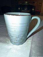 Front view of the blue mug showing weave pattern and handle